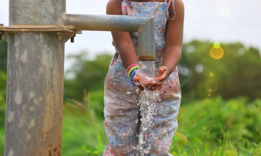 girl-washing-her-hands-at-a-water-well-in-burkina-faso-africa-e1659542851666.jpg